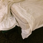 a bed with a white sheet on top