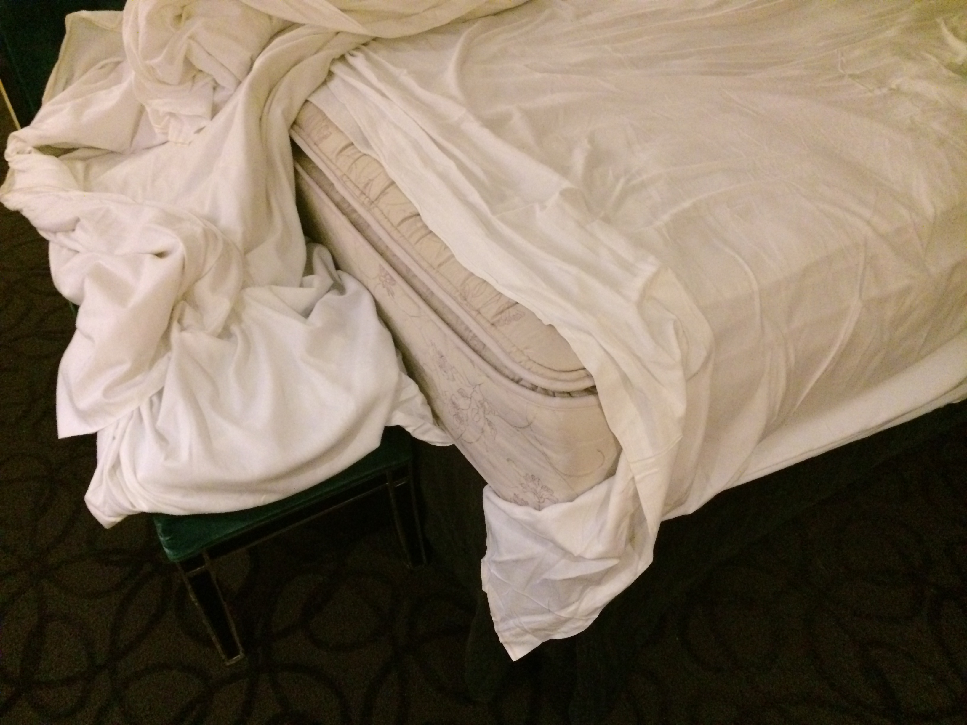 a bed with a white sheet on top