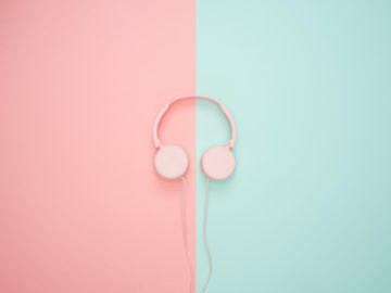 a pink headphones on a pink and blue background